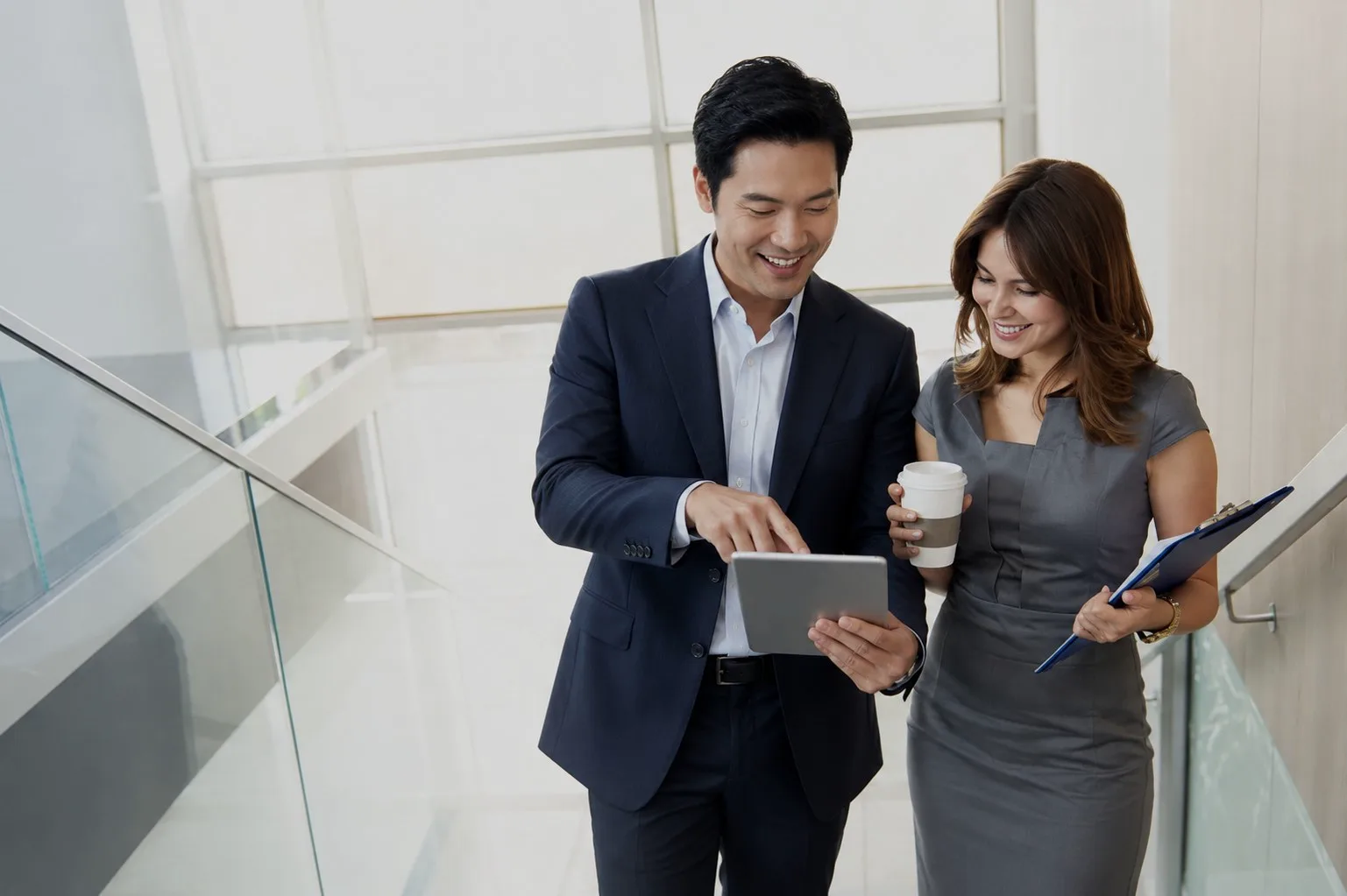 Two professionals reviewing a tablet together — direct access to the people making decisions