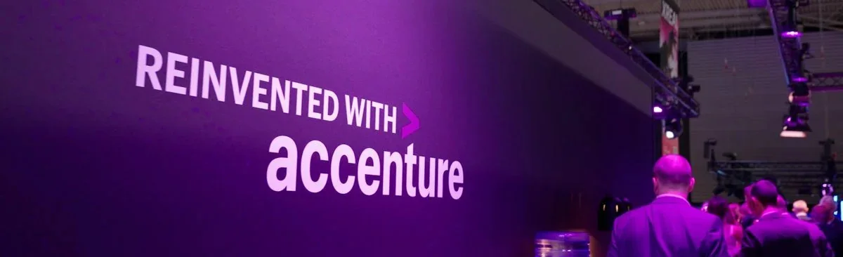 Reinvented with Accenture — conference banner.